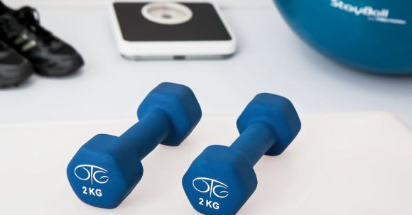 Home Fitness - Two 2 Kg. Blue Hex Dumbbells on White Surface