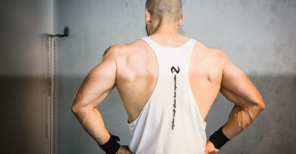 Burn Fat, Build Muscle - Backview of Brawny Man with Broad Shoudlers in White Tank Top