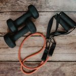 Home Workouts - orange and black usb cable on brown wooden surface