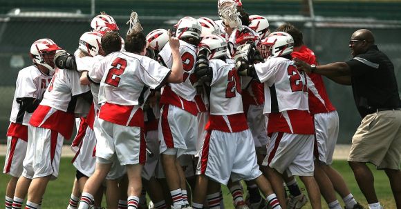 Sports Success - Group of Lacrosse Players Celebrating With Coach during Daytime
