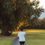 Cardio Workouts. - Unrecognizable woman jogging along footpath in park