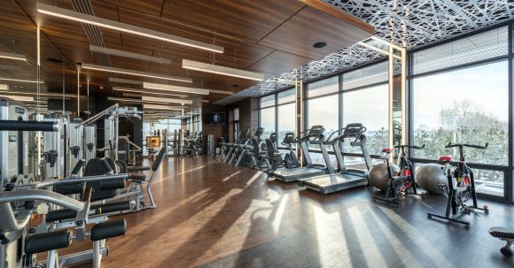 Cardio Workouts - Interior of modern fitness club with various machines and equipment