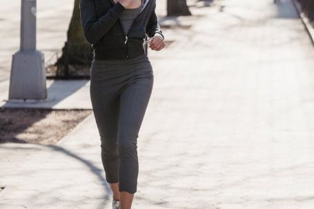 Cardio Workouts - Full body of active young ethnic female millennial with dark curly hair in sportswear running on city street during morning workout on sunny day