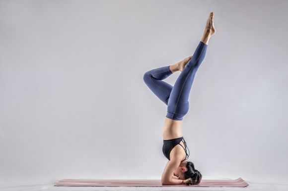 Yoga - woman in blue denim jeans and black leather shoes