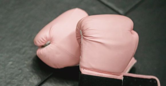 Fit Challenge - Boxing gloves on sports mat in gym
