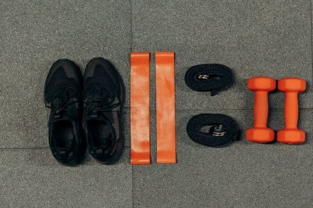 Weight Loss Program - Black Sneakers And Gym Tools on Gray Floor