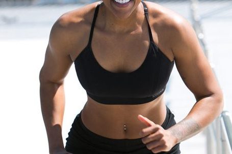 Rhythm, Weight - Woman Wearing Black Sports Bra and Jogger Shorts Smiling