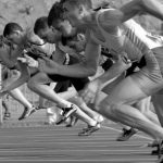 Start Here - Athletes Running on Track and Field Oval in Grayscale Photography