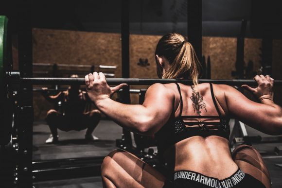 Strength Training - woman lifting barbel