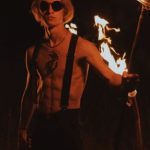 Fit Domination - Blond Man with Bare Torso and Torches at Night
