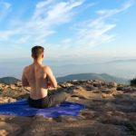 Meditation Integration - Shirtless Man Meditating on Mountain Top