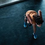 Sport Training - woman in orange top exercising indoors