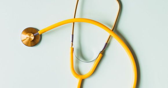 Prevent Imbalances - Top view of yellow medical stethoscope placed on white surface during coronavirus pandemic
