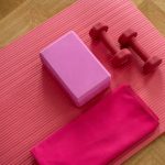 Strength Training - pink dumbbell on pink textile