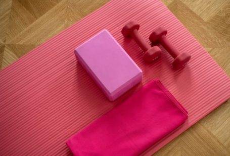 Strength Training - pink dumbbell on pink textile
