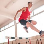 Sports Performance - Woman in Red Tank Top Jumping on Obstacle