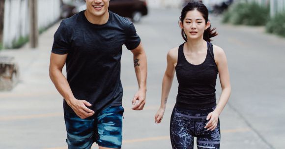 Sports Training - Man and Woman Running in City