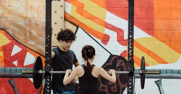 Sports Training - Young Athletes Lifting Weights at Gym with an Orange Mural