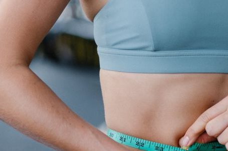 Weight Loss Programs - Fit Woman Using Measuring Tape