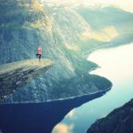 Relaxation Techniques - Person Standing on Rock Formation