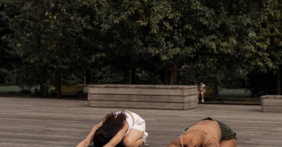 Core Strength, Posture - Faceless women practicing Extended Childs pose in nature