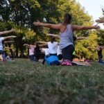 Muscle & Balance - Women Performing Yoga on Green Grass Near Trees