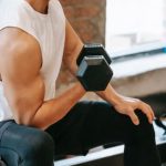 Fit Challenge - Muscular Asian man pumping bicep