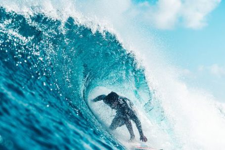 Fit Challenge - Unrecognizable energetic surfer riding azure sea wave