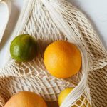 Budget-friendly Nutrition. - Assorted citrus fruits in cotton sack on white surface