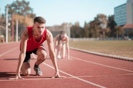 Cardio Tips - Strong sportsmen ready for running on stadium