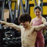 Sports Training - Man Exercising with Dumbbells in Gym