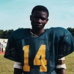 Champion Training - Black player of American football on stadium
