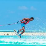 Sports-specific Training - man in red tank top doing water sports during daytime