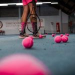 Sports-specific Training - a person standing on a tennis court with a racket