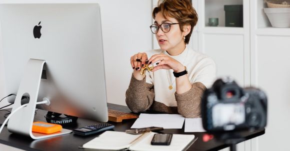Online Coaching - Confident elegant lady in eyeglasses hosting webinar